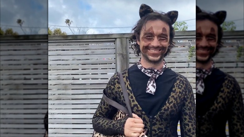 Joseph Gordon-Levitt wearing cat ears, cheetah-print clothing and accessories, and messy brown makeup