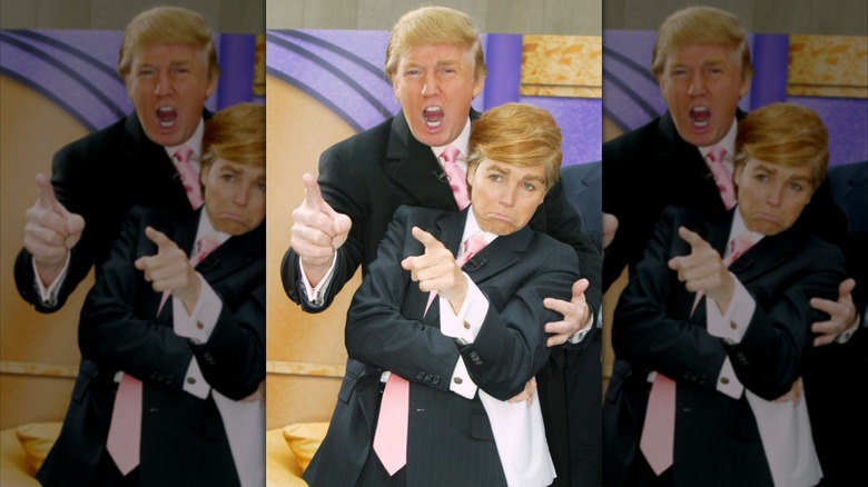 Donald Trump pointing and posing with his mouth open behind Katie Couric, who is dressed like him