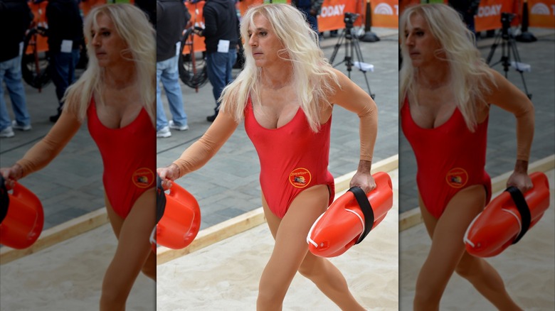 Matt Lauer wearing a blond wig and running in a red "Baywatch" swimsuit