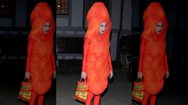 Katy Perry wearing a Cheetos costume and carrying a Flamin' Hot Cheetos handbag