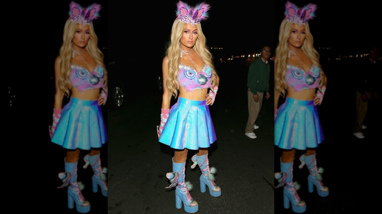 Paris Hilton wearing an iridescent miniskirt, a top with a Furby's face on it, and a headpiece topped with furry ears