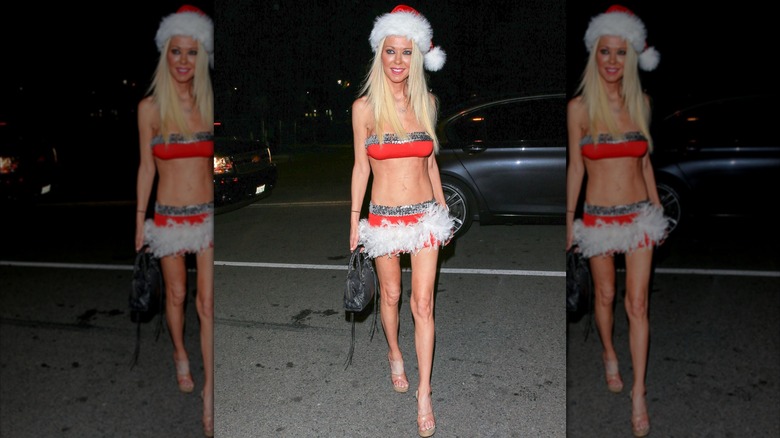 Tara Reid wearing a red bandeau top, Santa hat, and skirt trimmed with feathers