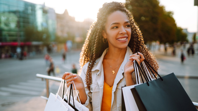 woman smiling with shopping bags