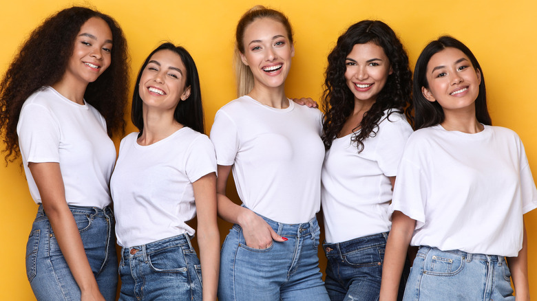 Smiling women wearing white t-shirts
