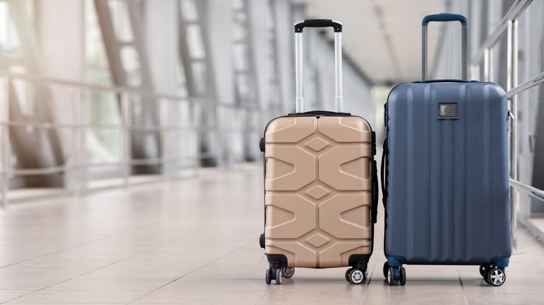 two suitcases in an empty airport