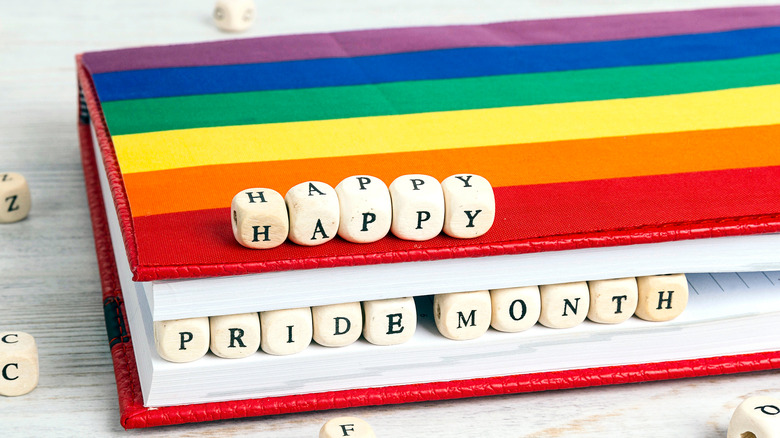 A book with the words "Happy Pride Month"
