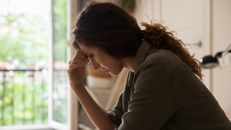 grieving woman looking down