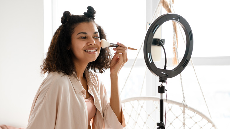 Woman applying makeup