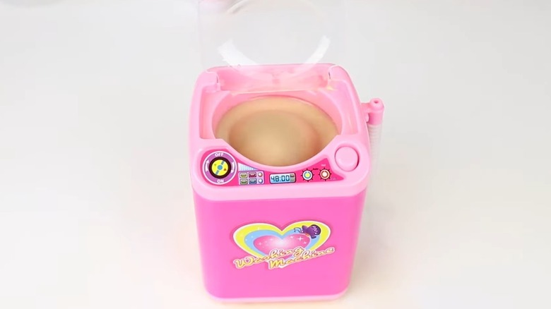 Beauty blender in a toy washing machine