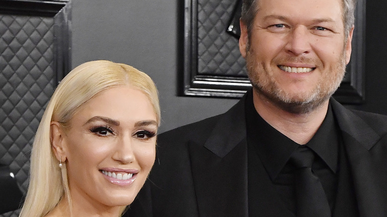 Gwen Stefani and Blake Shelton on red carpet smiling