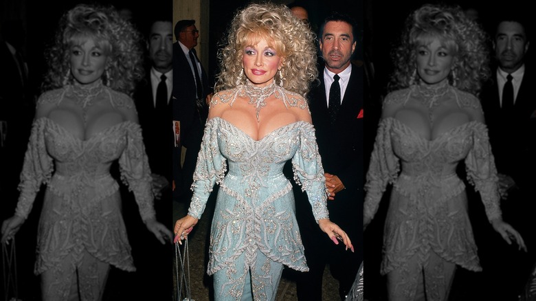 Dolly Parton walking in front of suited men