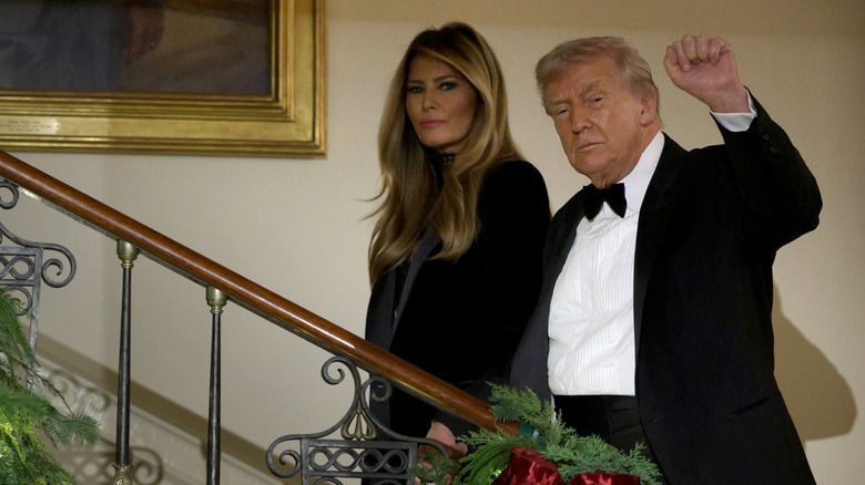 Donald and Melania Trump walking up stairs