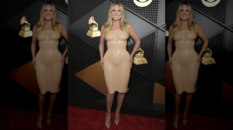 Heidi Klum smiling in a nude-colored PVC dress
