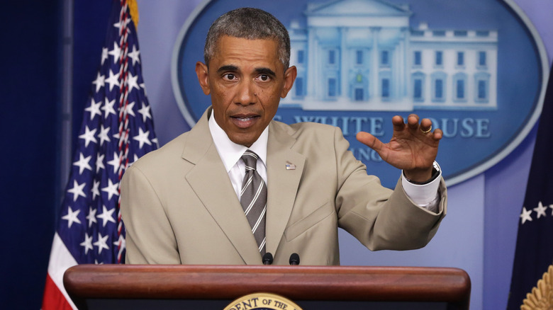 Barack Obama addressing reporters in his tan suit