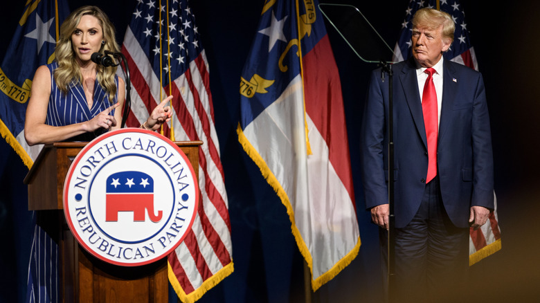 Donald Trump standing on stage with Lara Trump