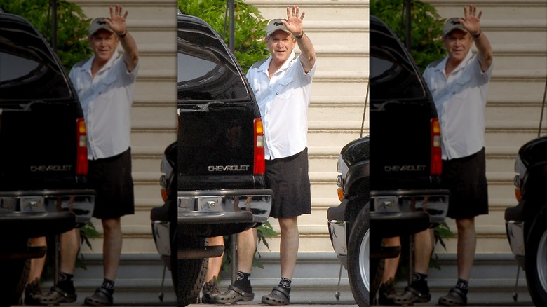 George W. Bush waving at the camera wearing his Crocs