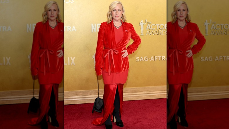 Patricia Arquette posing in a red outfit at the 2026 Actor Awards