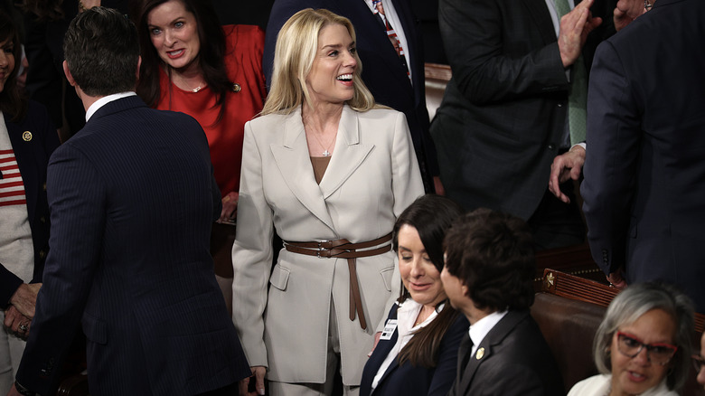 Pam Bondi smiling at the 2026 State of the Union while wearing a jacket.