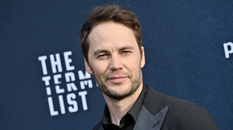 Taylor Kitsch smiling at premiere