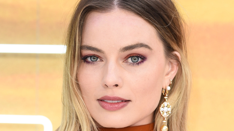 Margot Robbie poses at an event 