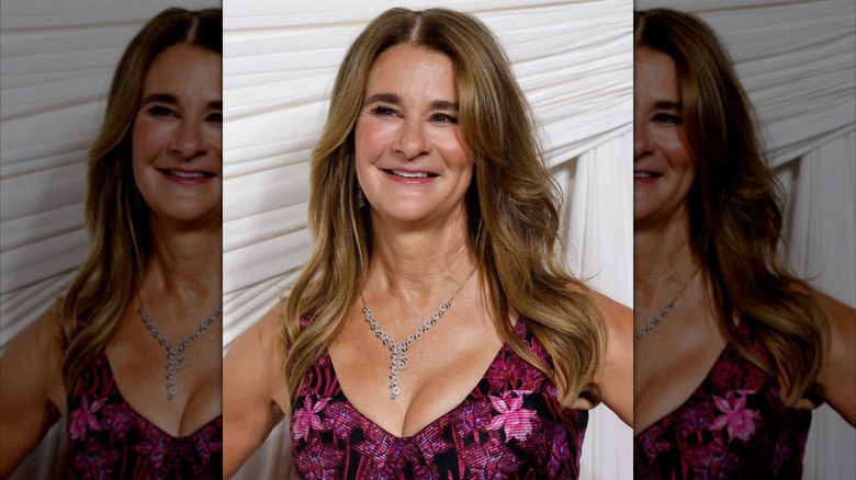 Melinda French Gates smiling in a pink floral dress