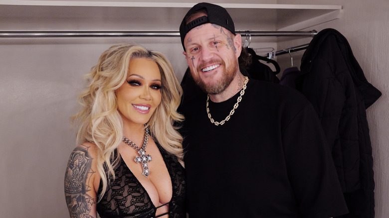 Bunnie Xo and Jelly Roll smiling while posing together in all-black outfits