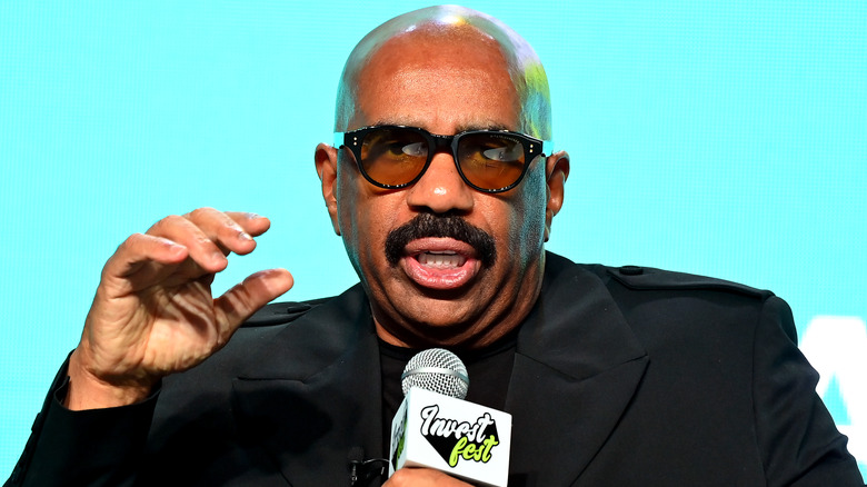 Steve Harvey speaking into microphone