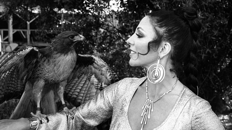 Joan Collins with a falcon on the set of "The Fantastic Journey" (1977)