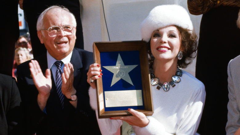 Joan Collins posing with her Walk of Fame plaque in 1983