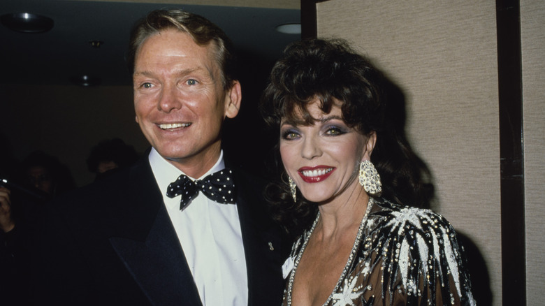 Joan Collins (right) and Bob Mackie (left) at an AIDS charity event in 1989