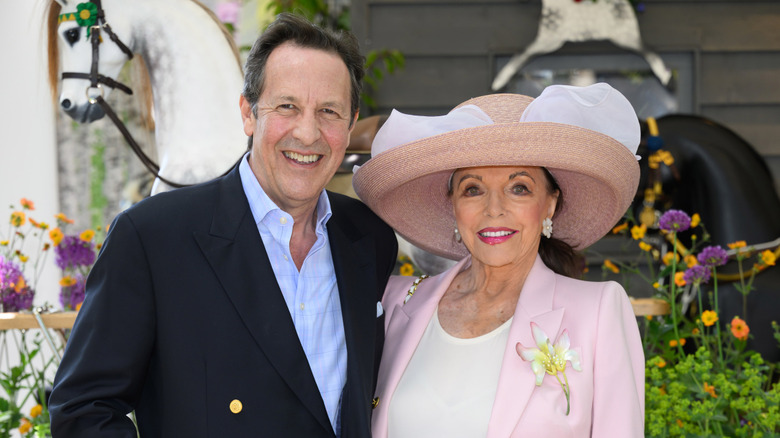 Joan Collins (right) and Percy Gibson (left) posing for a photo in 2024