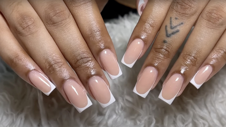 Woman with white french tip nails
