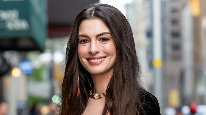 Anne Hathaway gold necklace NYC background