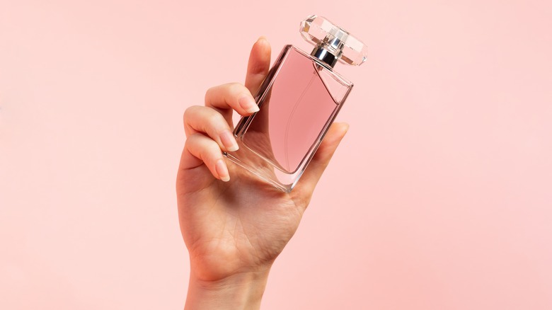 A woman holding perfume