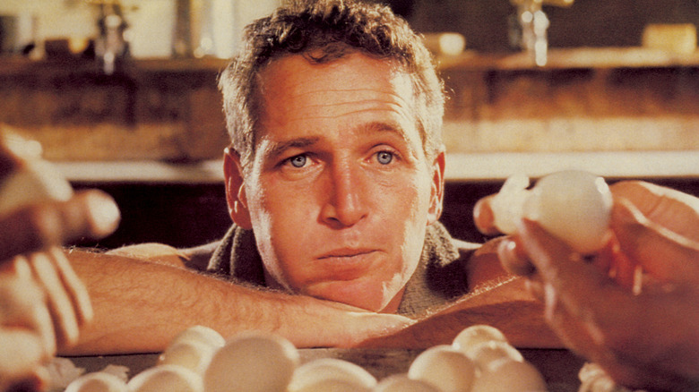 Paul Newman (1925 - 2008) as Luke, attempting to eat fifty hard-boiled eggs in an hour in the film 'Cool Hand Luke', 1967.