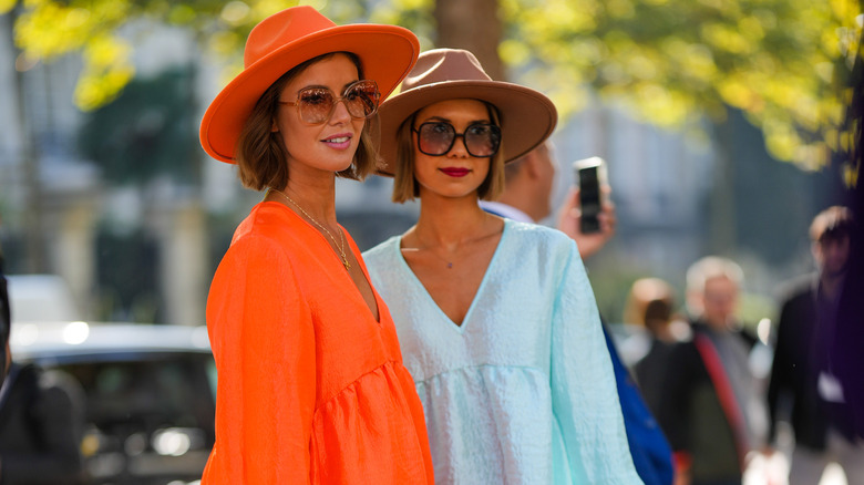 Two women in babydoll dresses outside