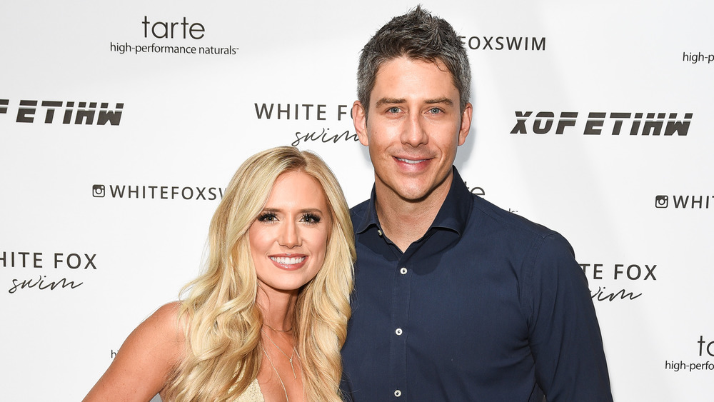 Arie Luyendyk and Lauren Burnham pose at event