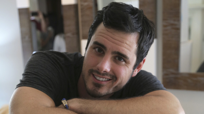 Ben Higgins leaning on box