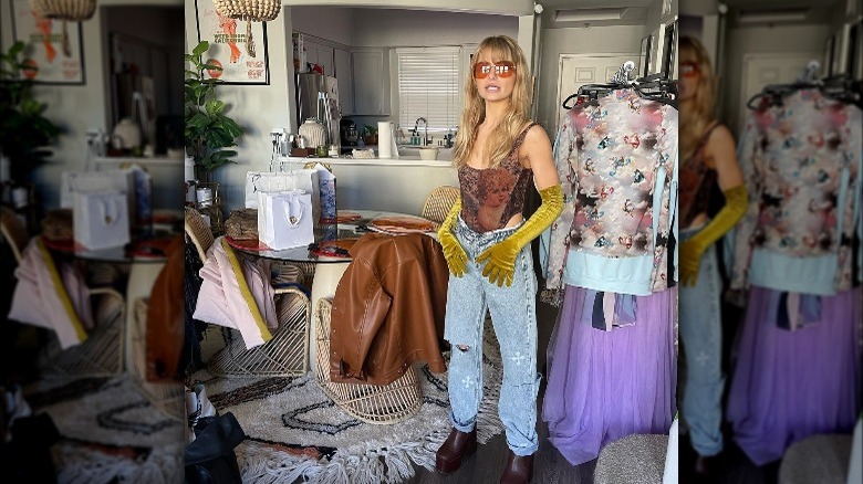 Demi Burnett stands with racks of clothes