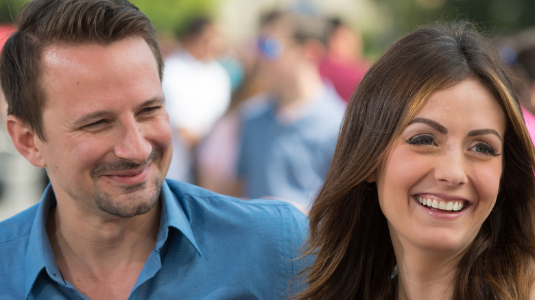 Evan Bass and Carly Waddell smile together 