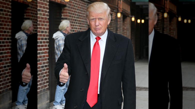 Donald Trump giving a thumbs up with his way-too long tie hanging down