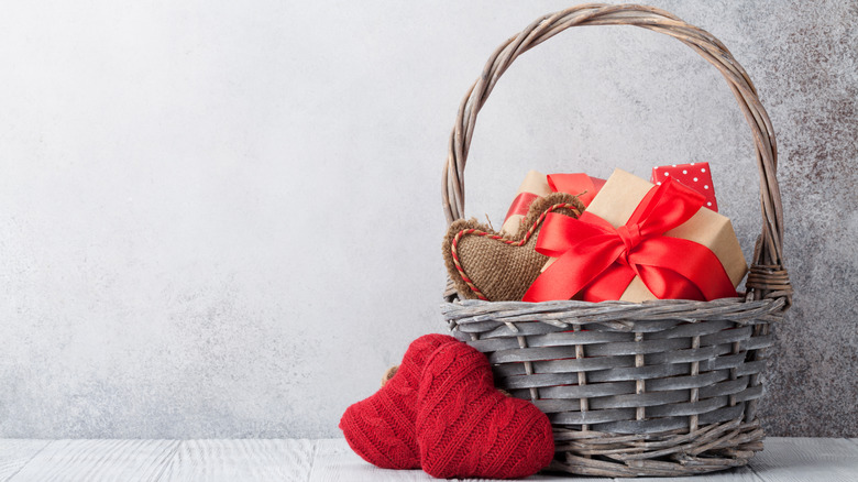 Basket with gifts and knit hearts