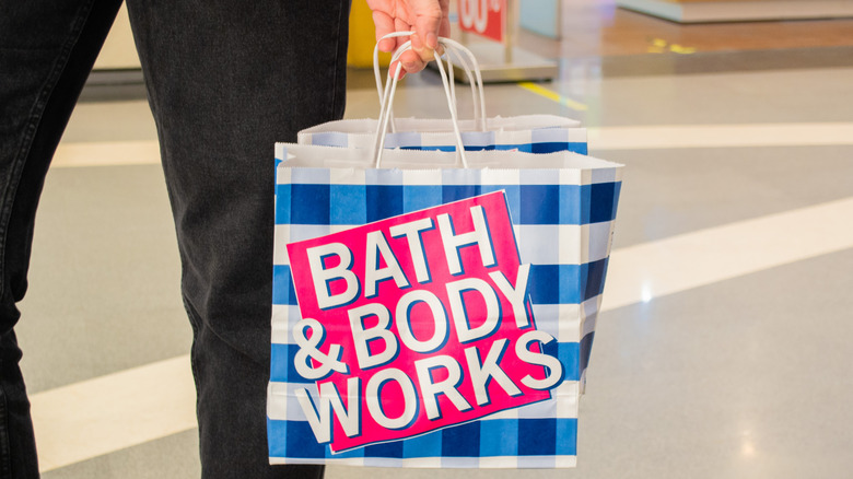Man holding Bath and Body Works bag