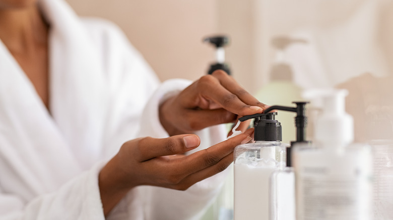 woman using products in her bathrobe