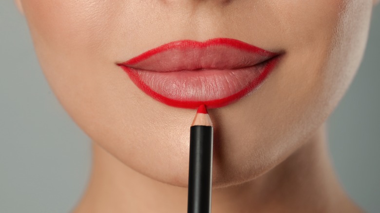 woman applying lip liner 