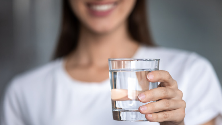 Holding glass of water