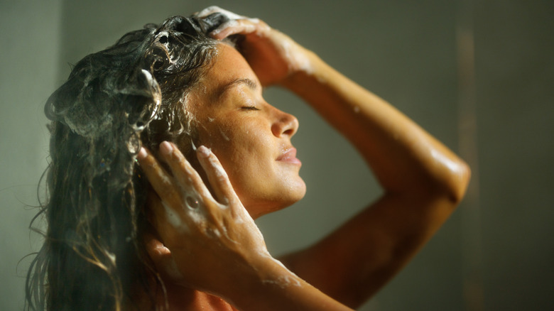 Woman showering with shampoo 