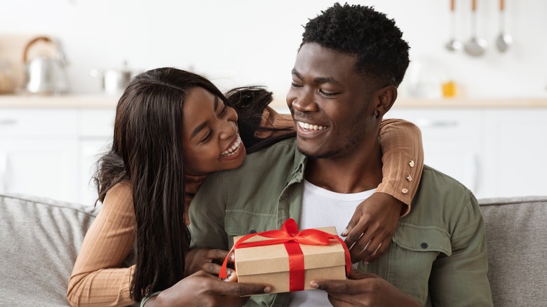 Woman giving man gift