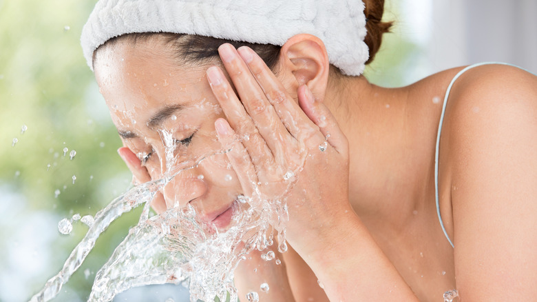 woman washing her face