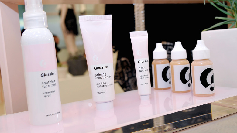 Glossier products on a shelf in the store